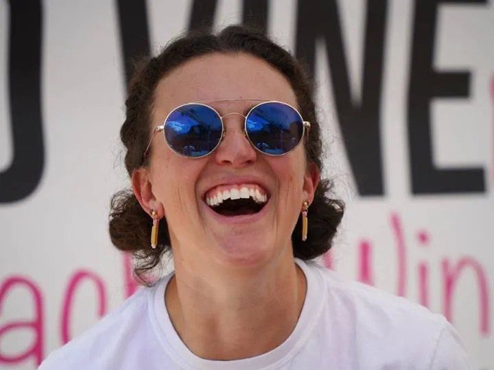 Britt laughing at a wine festival
